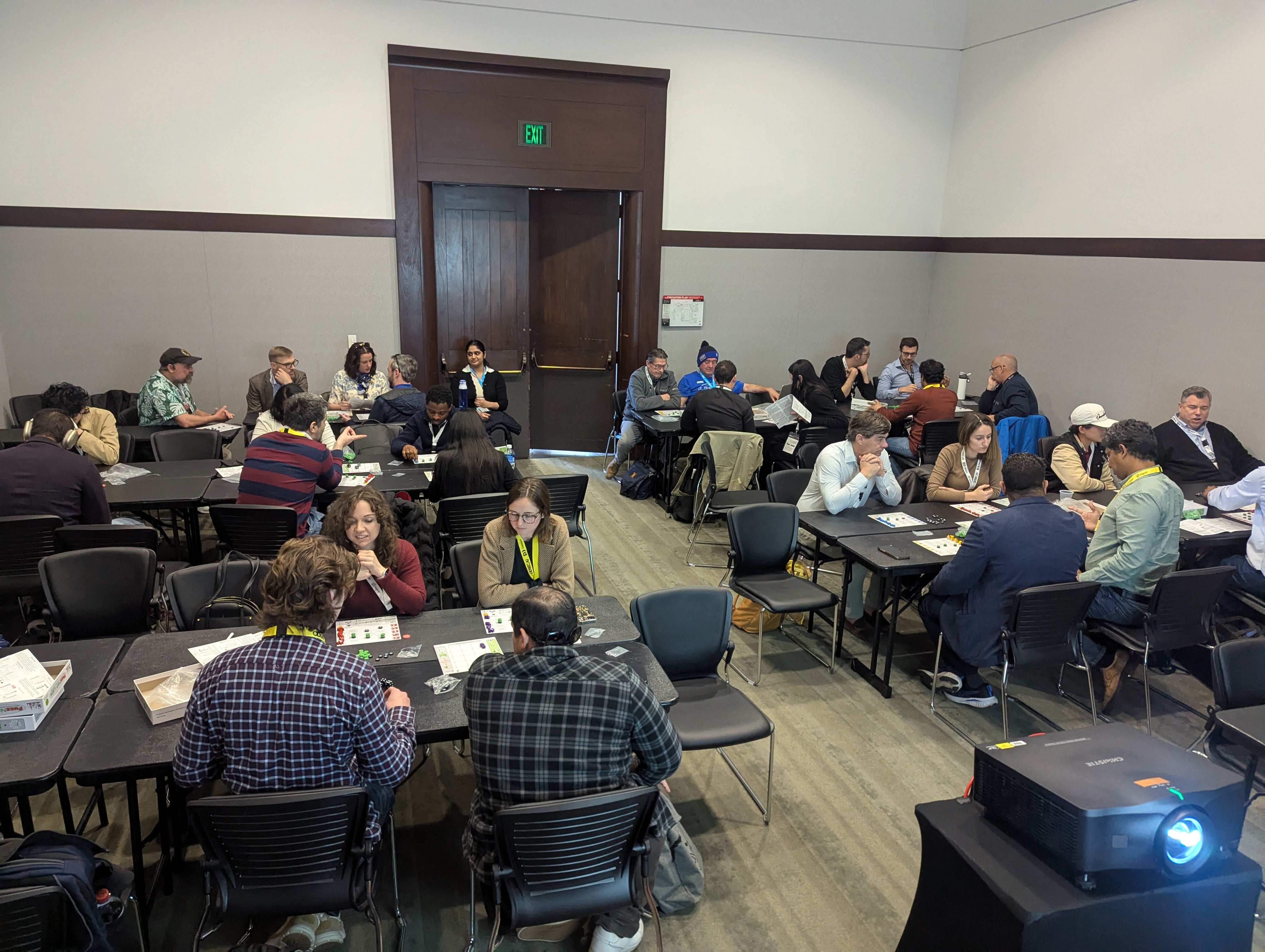 A full room of participants in a hands-on FuzzNet Labs session, in person at tables