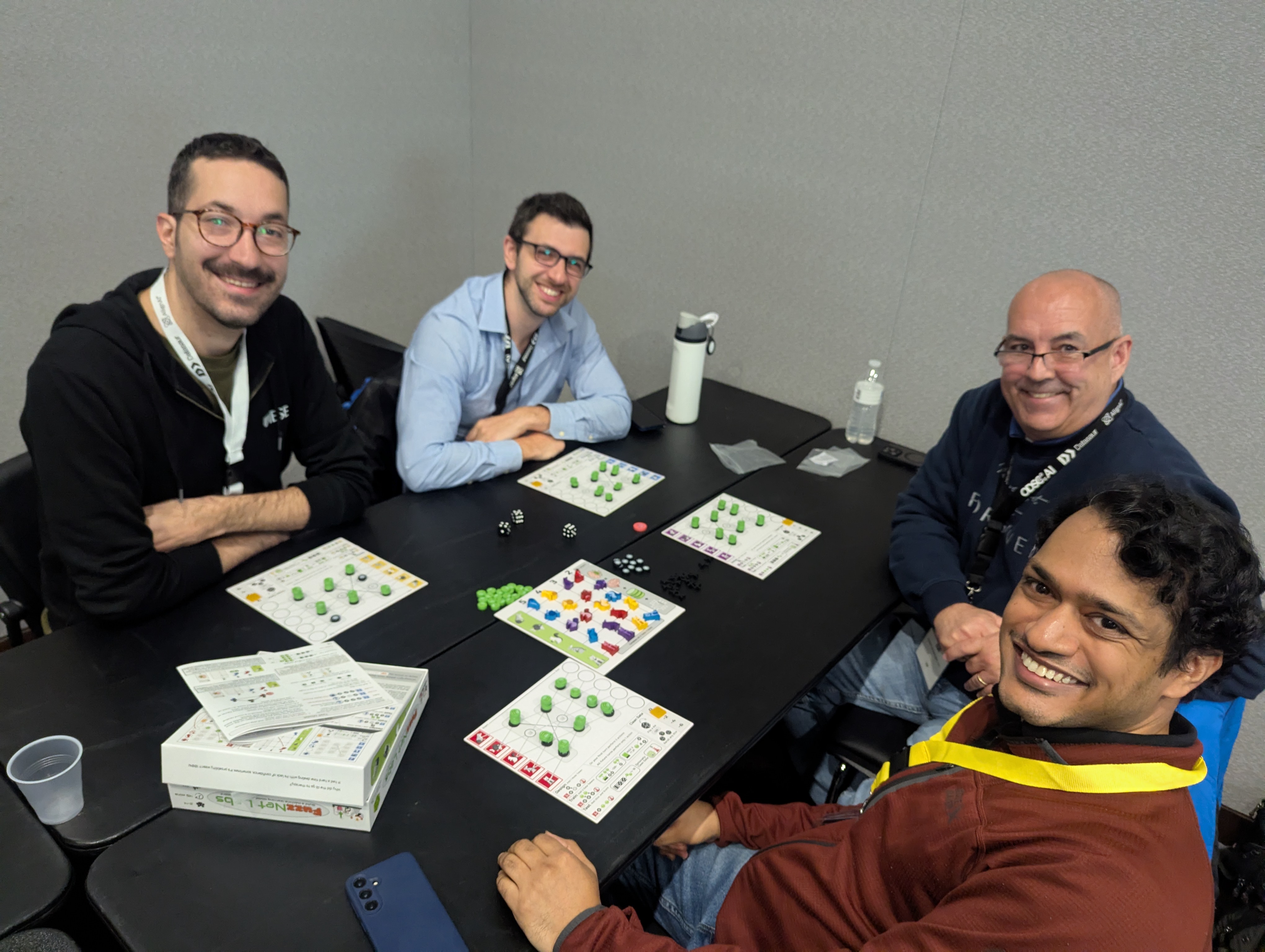 Participants engaged in a FuzzNet Labs session across two tables
